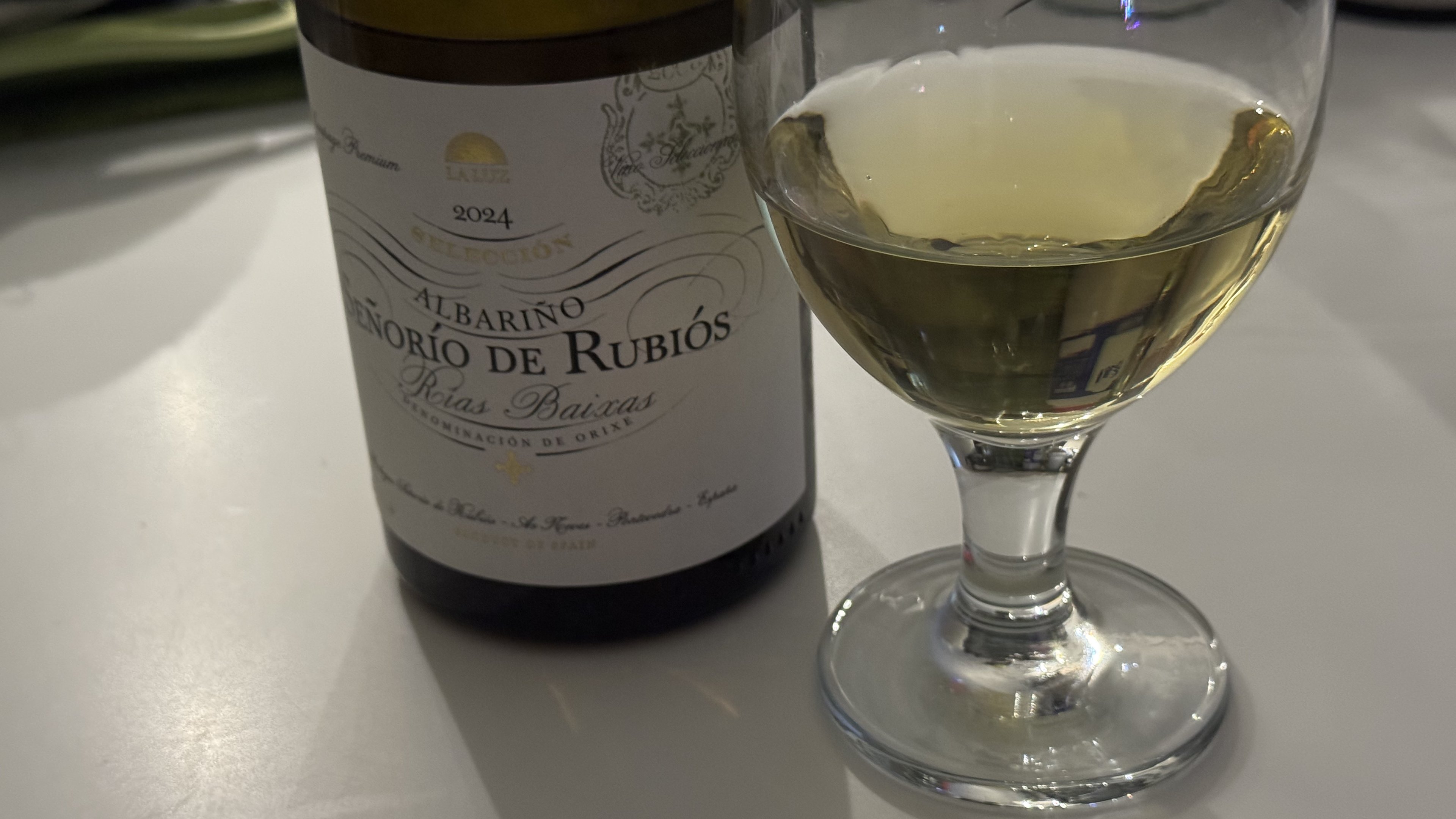 Bottle of Señorío de Rubiós Albariño beside a poured glass, Rías Baixas label